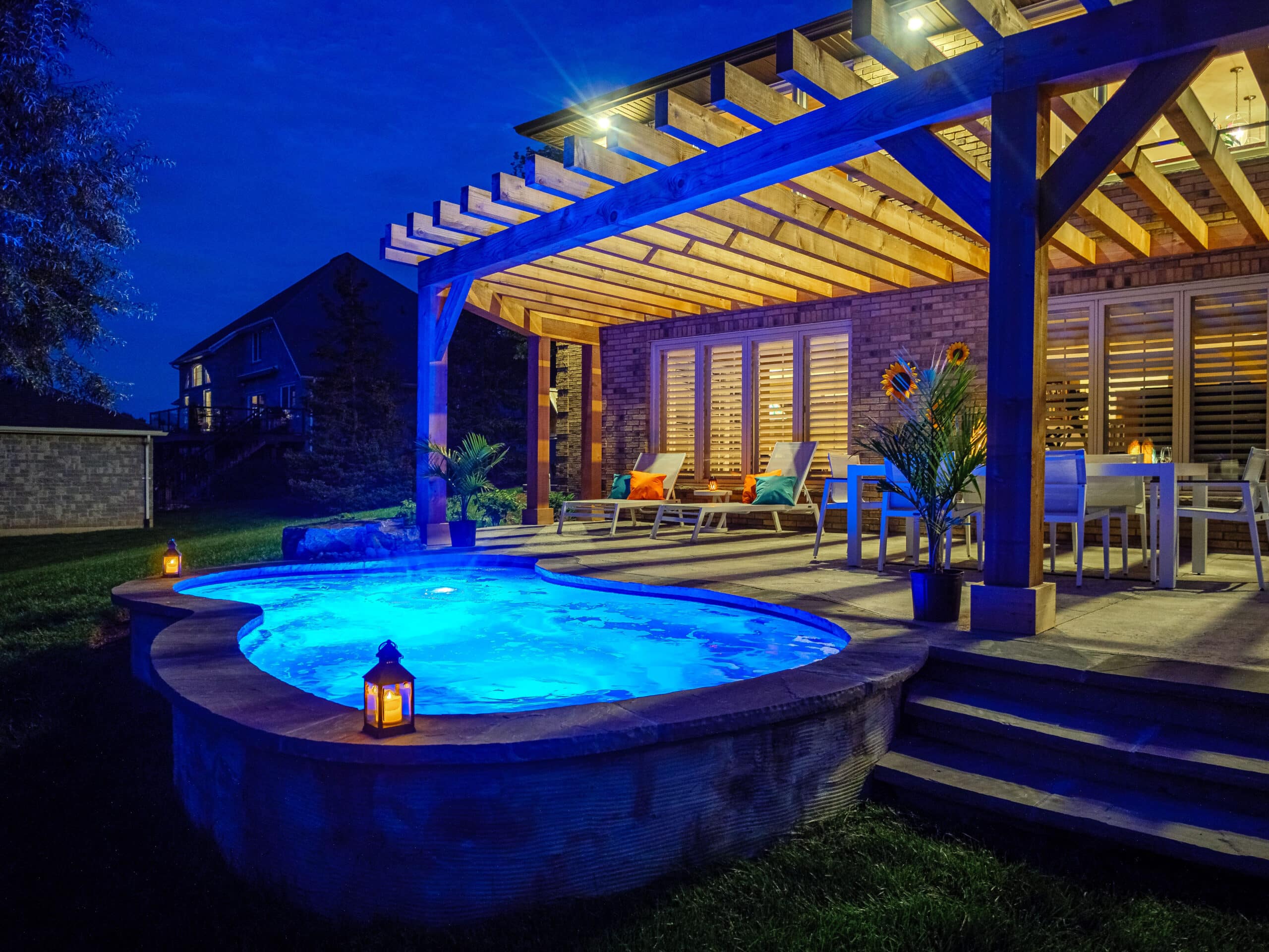 inground hot tub fiberglass pools Immerspa pool lit with blue lights